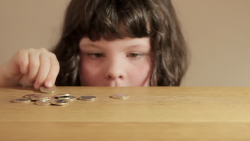 Small girl counting Euro coins