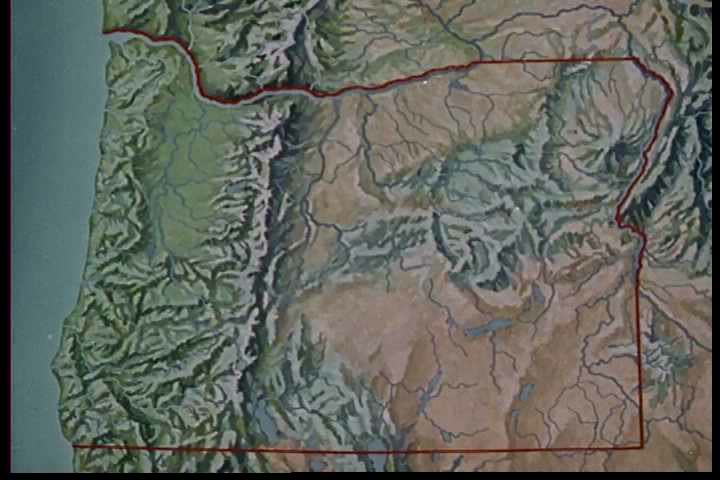 1970s: A map of Oregon shows mountain ranges and riverbeds; footage of them is shown in 1970.