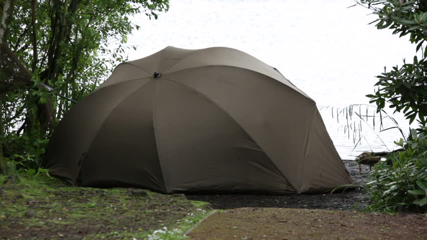 Fisherman in the tent fishing at the lake