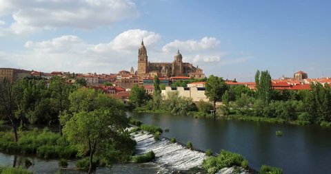 Aerial footage. The Cathedral of Salamanca reflected in the Tormes river. Spain. 