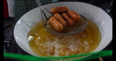 Frying the Codfish Balls (in Portuguese: Bolinho de Bacalhau) - tradicional portuguese food