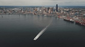 Aerial footage over water and over downtown chasing a boat. Seattle 2015. 4K uncompressed.