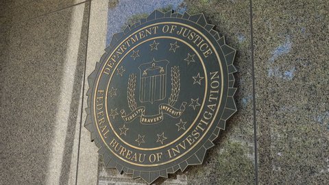 WASHINGTON, DC - JUNE 4, 2017: FBI seal - zoom out, Federal Bureau of Investigation headquarters building -  J. Edgar Hoover Building, Washington, DC. FBI operates under the U.S. Justice Department.