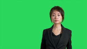 Chinese news reporter or presenter on green screen showing product or weather space