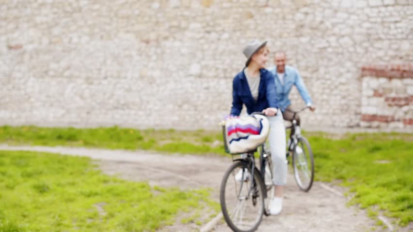 Happy mixed race couple cycling
