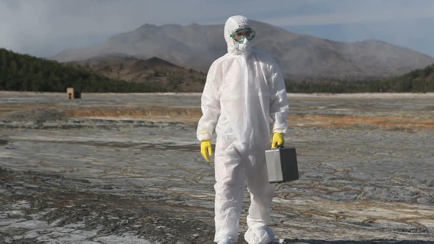 Chemical professional with suitcase walking in the contaminated areas
