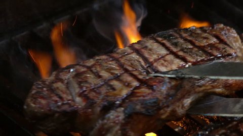 High quality video of grilling steaks on fire in real 1080p slow motion 120fps