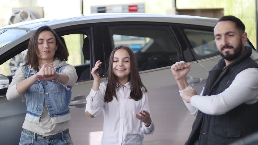 Family celebrating buying a new car.