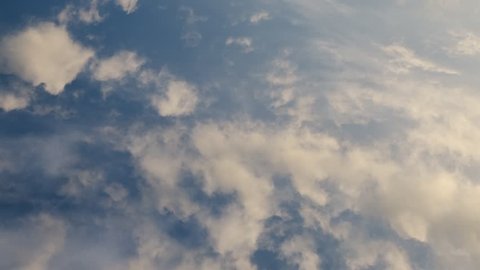 Time lapse video of white cumulus and fleecy clouds morphing on blue sky, 4K