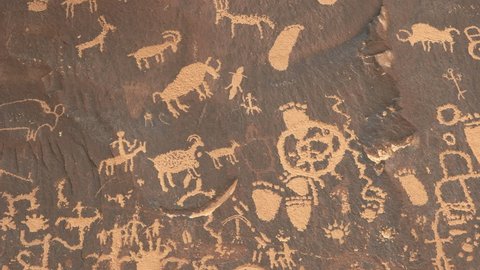 zoom in shot on a drawing of a human figure on horseback hunting sheep at newspaper rock in canyonlands national park, utah