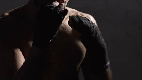Male athlete shade boxing in the gym, Muay Thai boxer training before fight