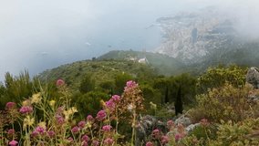 Aerial View of Mountain with Fog and Flowers. Principality of Monaco in the Background - 4K Video