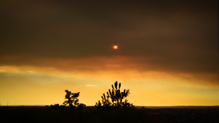 Dramatic sunrise time lapse. Forest fire smoke.