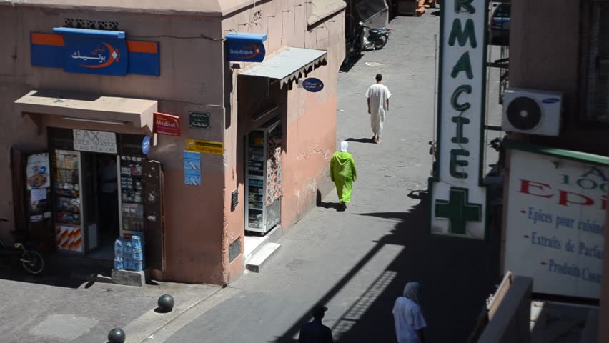 MARRAKECH, MOROCCO - CIRCA 2012: People walk in the street at midday circa July
