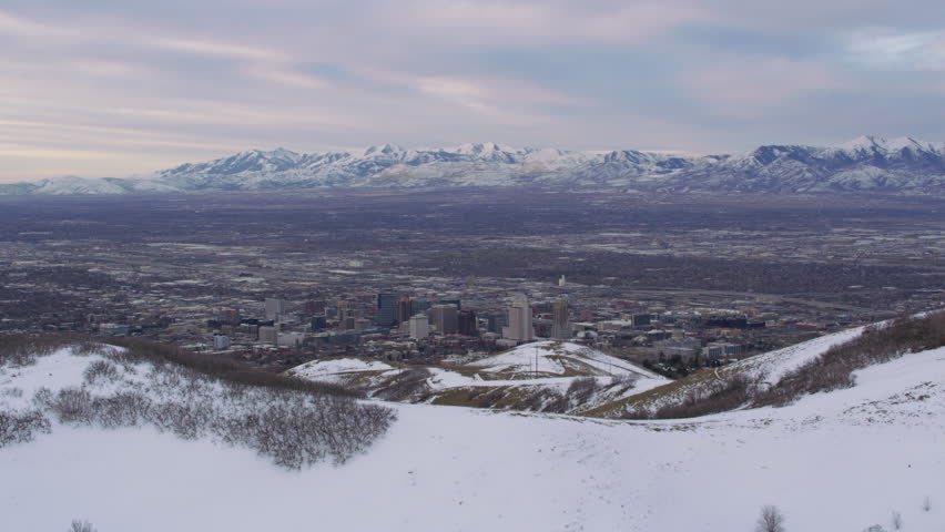 Salt Lake City, Utah circa-2017, Fly over snow covered hills to reveal Salt Lake City