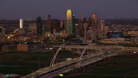 Dallas, Texas circa-2017, Aerial view of Margaret McDermott arch bridge and city at dusk