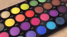 Eye shadow, powder palette, fashion set, bright, colorful cosmetics. Paint for face, glamor makeup close-up of color. Slow motion video HD.