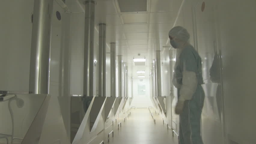 Long bright corridor in scientific laboratory building. scientists enter and exit.