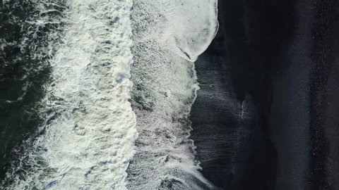 Epic (4K) Drone/Aerial footage of waves breaking against an Icelandic black sand beach, known as Vík í Mýrdal. One of the most beautiful and wettest beaches in the world, created from black basalts.