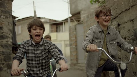 4K. Kids, Friends riding bikes, bicycles. Vintage times. Memories. Shot on RED EPIC DRAGON Cinema Camera in slow motion. Stockvideo