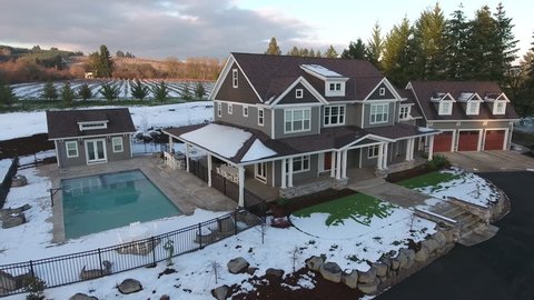 Aerial view of country home in Winter with snow.