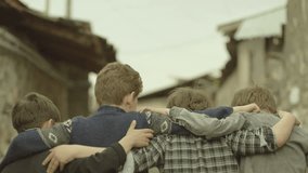 Childhood Memories.  Back view of a group of teen friends enjoying a walk, hugging each other. Vintage times. Shot on RED EPIC DRAGON Cinema Camera in slow motion.