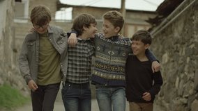 Childhood Memories.  View of a group of teen friends enjoying a walk, hugging each other. Vintage times. Shot on RED EPIC DRAGON Cinema Camera in slow motion.
