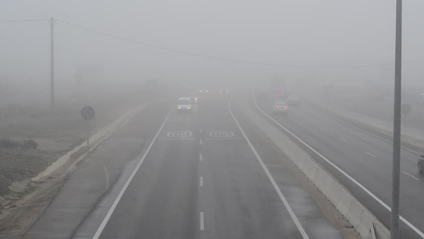 Cars in a highway with dense fog circa January 2012 in Leon, Spain.