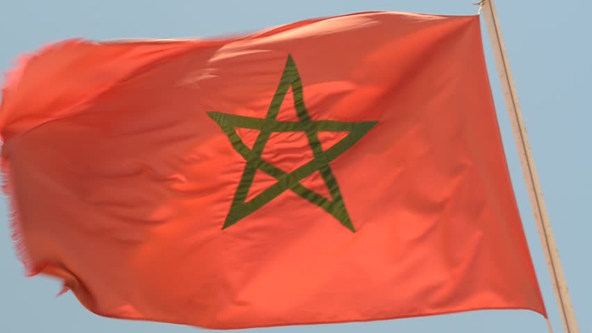 Morocco National flag waving against blue sky.