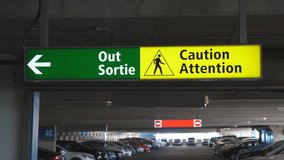 Green sign showing the way out with pedestrian warning. No entry sign in the background. Parking garage. Handheld stabilized shot.
 - Powered by Shutterstock - Get 15% off with code: PIKWIZARD15