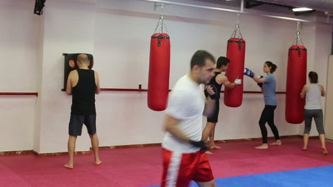 Men and women of different ages practicing boxing punches