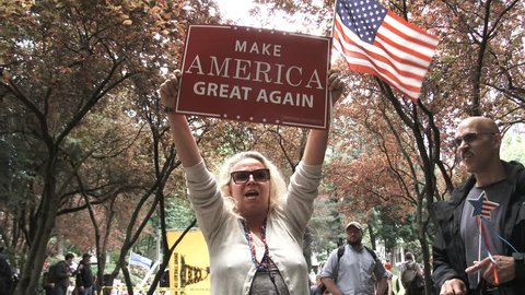 JUNE 4TH, 2017 - PORTLAND, OREGON: Woman holding sign reading Make America Great Again chants Trump Trump Trump at rally in Portland, Oregon.