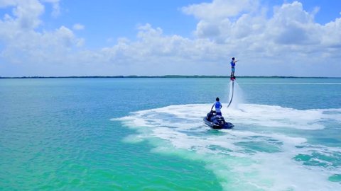 Flyboarding over Blue Water with Jetski
