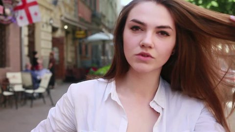 people, emotions, natural, beauty and lifestyle concept -Young beautiful woman close up portrait smiling in the street. video 4k, 3840, 2160, Ultra HD