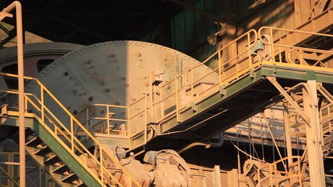 A ball Mill inside of a copper processing industry.
A ball mill, a type of grinder, is a cylindrical device used in grinding (or mixing) materials