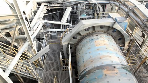 A ball Mill inside of a copper processing industry.
A ball mill, a type of grinder, is a cylindrical device used in grinding (or mixing) materials