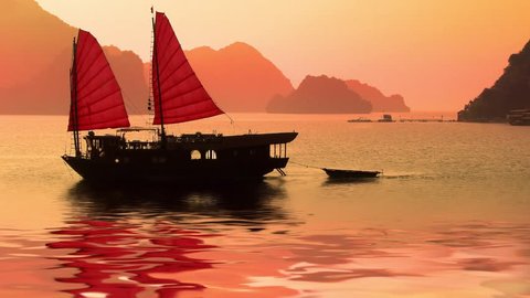 Seamless loop, Junk boat at sunset in Halong Bay, Vietnam - video HD