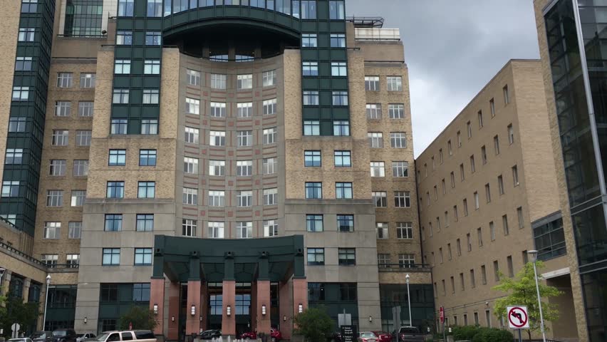 Establishing shot of generic hospital building in downtown metropolian area | Shutterstock HD Video #27622297