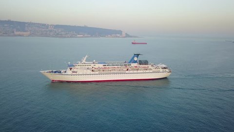 Haifa., Israel, 9 June 2017: The Golden Iris cruise ship on early morning light - aerial view 4k 