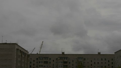 construction crane working on the background of the house and sky, timelapse, 1080p