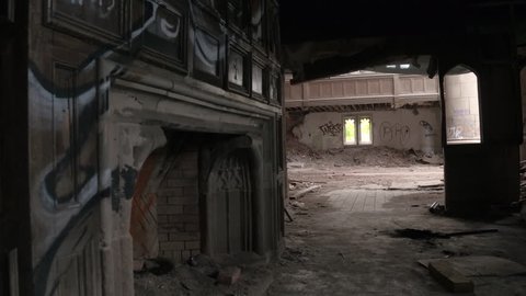 POV: Urban exploration of spooky abandoned City Methodist Church in Gary, USA. Big religious building collapsing. Graffiti on the walls, ruined pillars, broken dusty planks and demolished fireplace