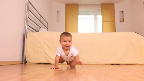 Adorable little baby crawling on the floor