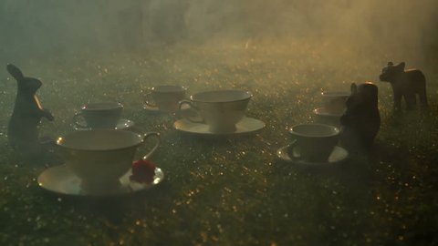 Fairy tea set on the grass in the smoke