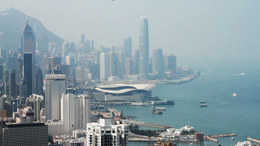 Hong Kong island skyline and pair of eagles flying over the city.