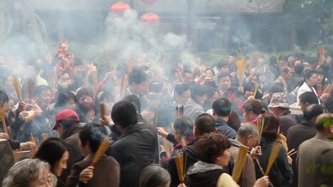 GUANGZHOU - FEBRUARY 3: People burn incense in temple during Chinese New Year on February 3, 2011 in Guangzhou, China.