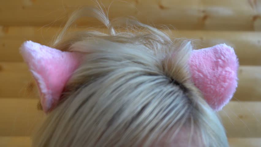 pink cat ears on the head of the girl.