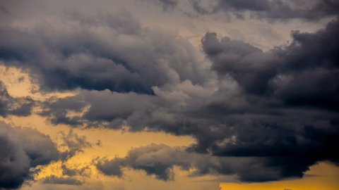 Ominous gloomy moody sky. Sever rainy bad weather clouds. Stormy clouds sky time lapse. Cloudscape form timelapse motion. Dark moody overcast sky clouds. Cloudy storm grey gray orange sky time lapse. 