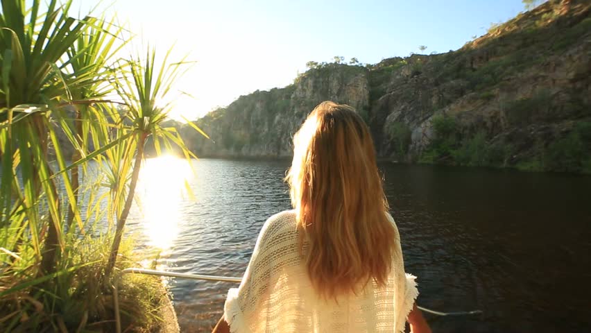 Taking the time to breathe it all in
Young woman by the lake arms outstretched. Beautiful Summer day.