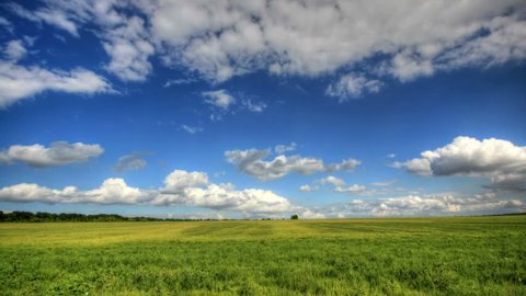 4K. Timelapse clouds over the green field. FULL HD, 4096x2304.
