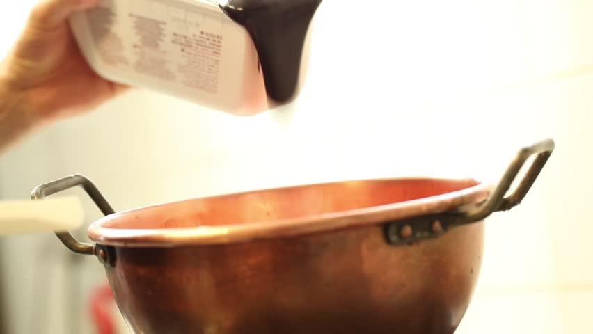 poring coulis in a copper pot